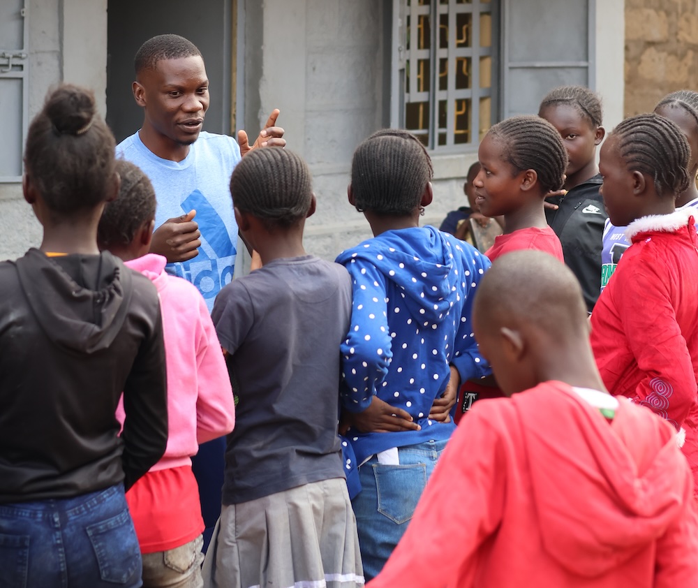 TEDS COMMUNITY HUB Teddy Omondi with children in Korogocho